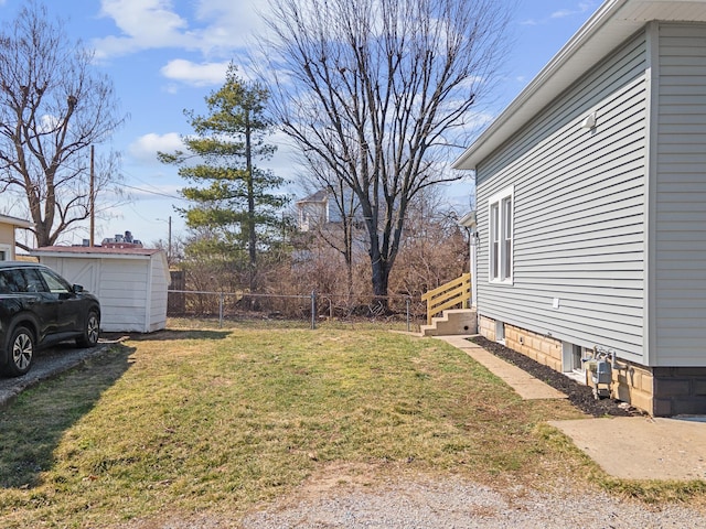 view of yard featuring an outbuilding and fence