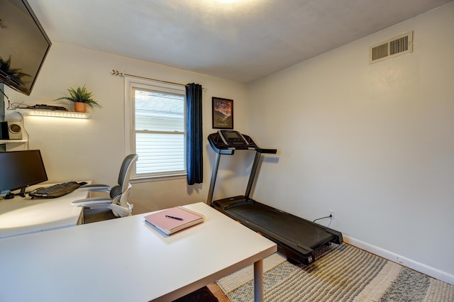 office space featuring baseboards and visible vents