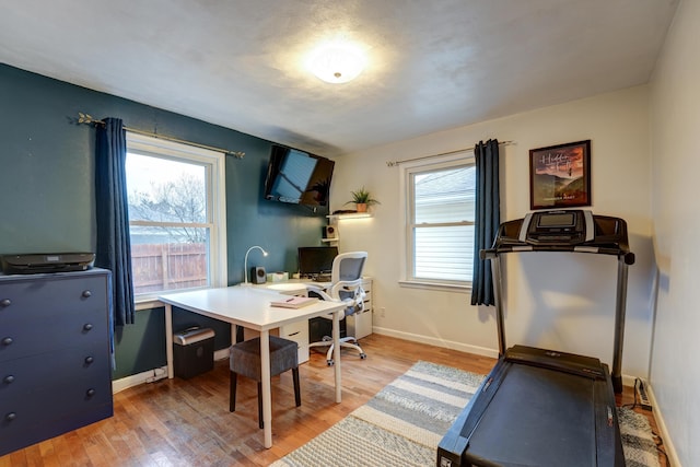 office space with light wood-style flooring and baseboards