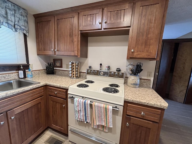 10209 County Road 286 Unit C-16, Huntsville, OH 43324 - kitchen featuring white electric range oven and light countertops