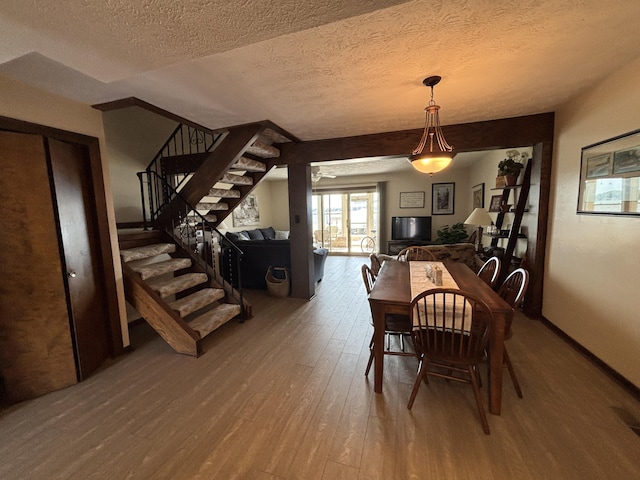 10209 County Road 286 Unit C-16, Huntsville, OH 43324 - dining room featuring wood-type flooring, stairway, and a textured ceiling