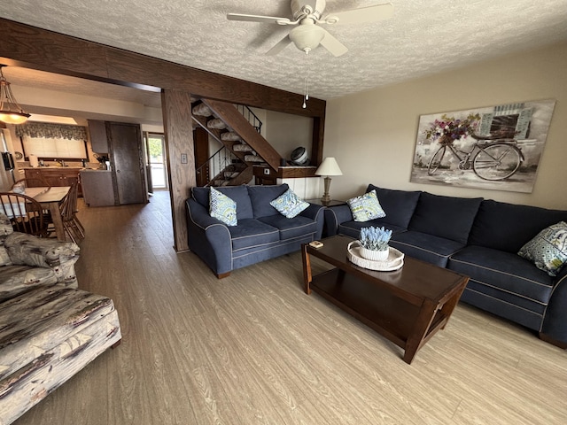 10209 County Road 286 Unit C-16, Huntsville, OH 43324 - living area featuring a textured ceiling, light wood-style floors, stairs, and a ceiling fan