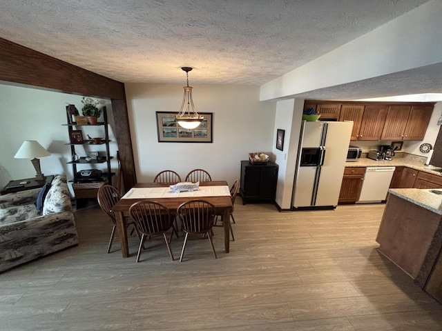 10209 County Road 286 Unit C-16, Huntsville, OH 43324 - dining room featuring a textured ceiling and light wood-type flooring