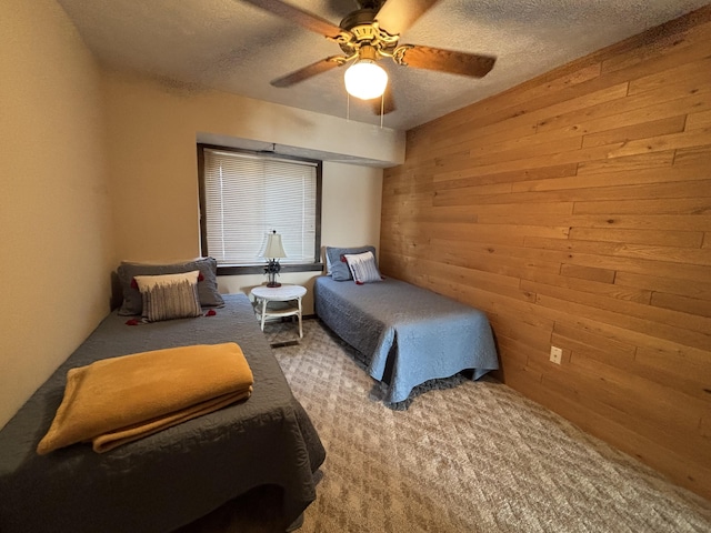 10209 County Road 286 Unit C-16, Huntsville, OH 43324 - bedroom featuring wood walls, carpet, a textured ceiling, and a ceiling fan