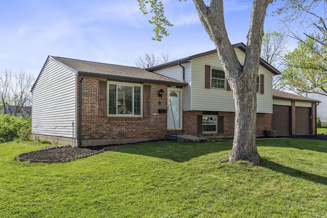 tri-level home featuring a front yard and brick siding
