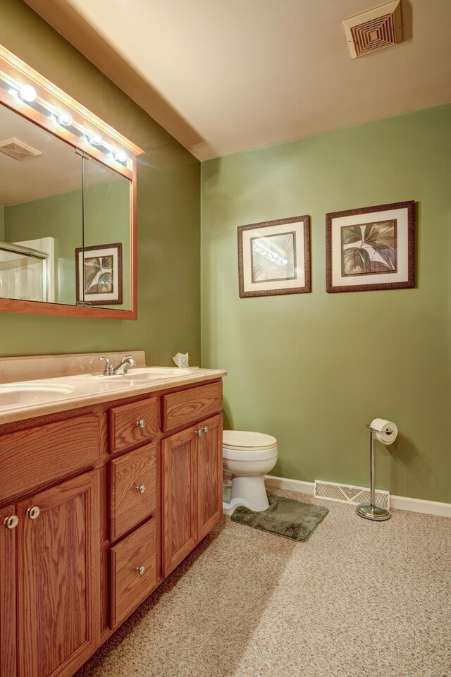 9743 State Route 118, Ansonia, OH 45303 - bathroom featuring vanity, toilet, baseboards, and a shower