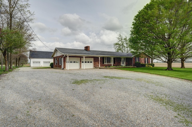 9743 State Route 118, Ansonia, OH 45303 - ranch-style home with gravel driveway, a garage, a chimney, brick siding, and a front lawn