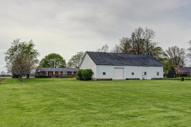 9743 State Route 118, Ansonia, OH 45303 - back of house with a lawn, an outdoor structure, metal roof, and a garage