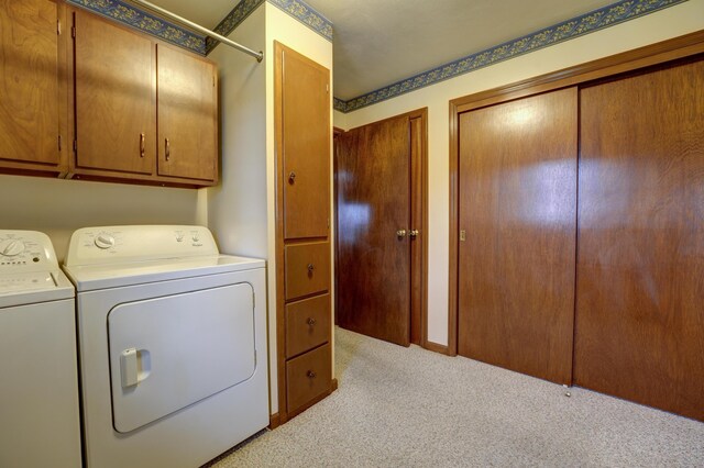 9743 State Route 118, Ansonia, OH 45303 - laundry area with washer and clothes dryer, light carpet, and cabinet space