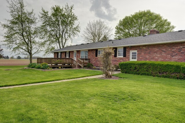 9743 State Route 118, Ansonia, OH 45303 - single story home with brick siding, a wooden deck, a front yard, and a chimney