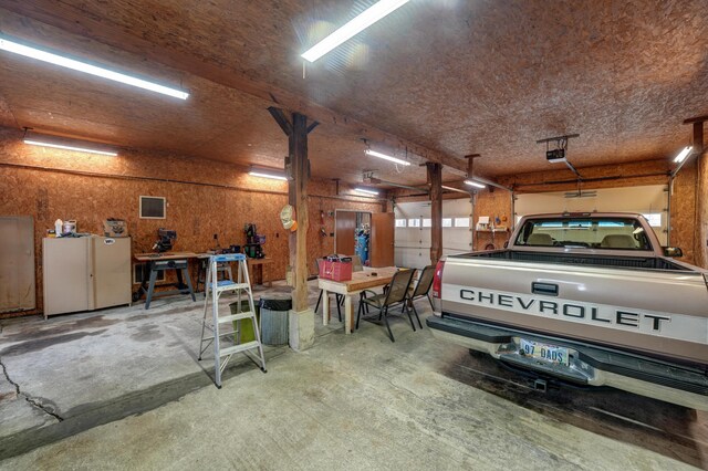 9743 State Route 118, Ansonia, OH 45303 - garage with a garage door opener and a workshop area