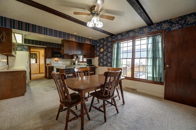 9743 State Route 118, Ansonia, OH 45303 - dining room featuring wallpapered walls, light colored carpet, ceiling fan, beamed ceiling, and baseboards