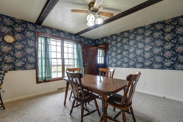 9743 State Route 118, Ansonia, OH 45303 - carpeted dining room featuring plenty of natural light, a ceiling fan, a wainscoted wall, beamed ceiling, and wallpapered walls