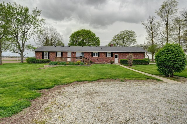 9743 State Route 118, Ansonia, OH 45303 - ranch-style house with brick siding, a deck, and a front lawn