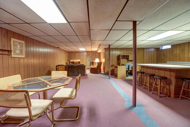 9743 State Route 118, Ansonia, OH 45303 - carpeted dining space featuring a bar, wooden walls, and a paneled ceiling