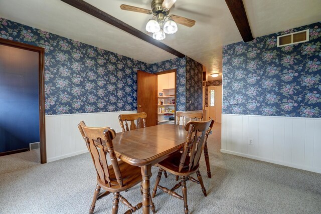 9743 State Route 118, Ansonia, OH 45303 - carpeted dining area with a ceiling fan, wainscoting, beamed ceiling, and wallpapered walls