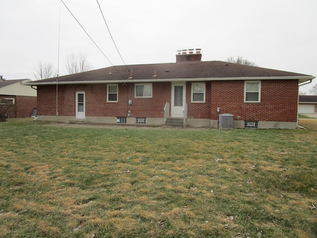 back of property with central air condition unit and a lawn