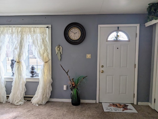 entryway with carpet floors and baseboards