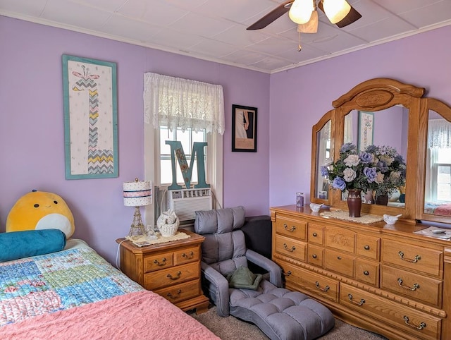 bedroom with a ceiling fan and crown molding