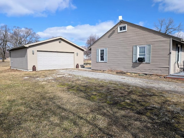 view of side of property featuring an outdoor structure and a detached garage