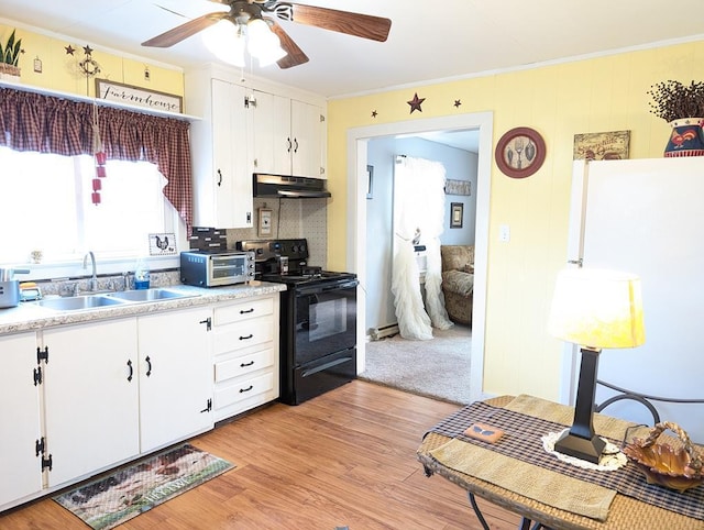 kitchen featuring light wood-style flooring, under cabinet range hood, black range with electric cooktop, white cabinetry, and a sink