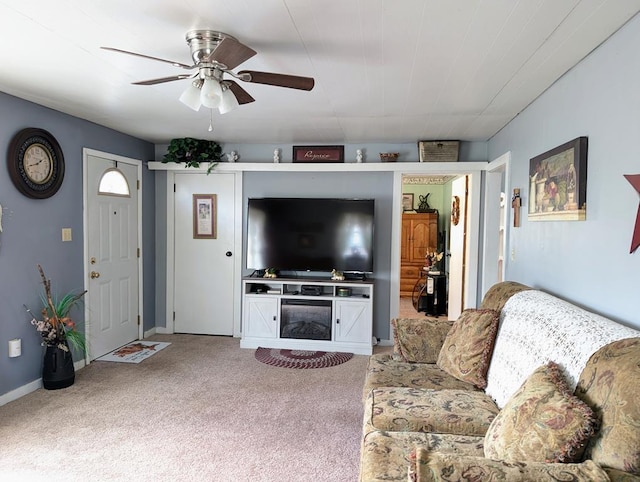 living area with ceiling fan, carpet, and baseboards