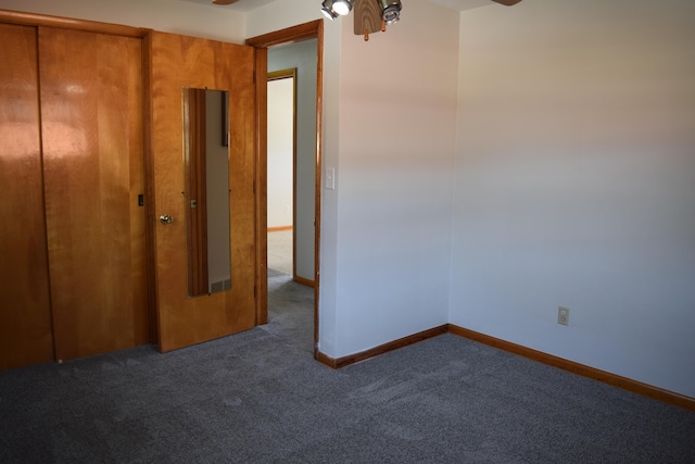 unfurnished bedroom featuring dark colored carpet