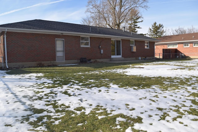 view of snow covered back of property