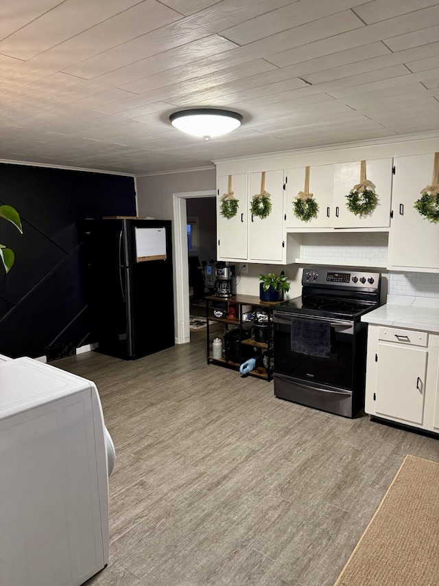 kitchen featuring light wood-type flooring, black appliances, and white cabinetry