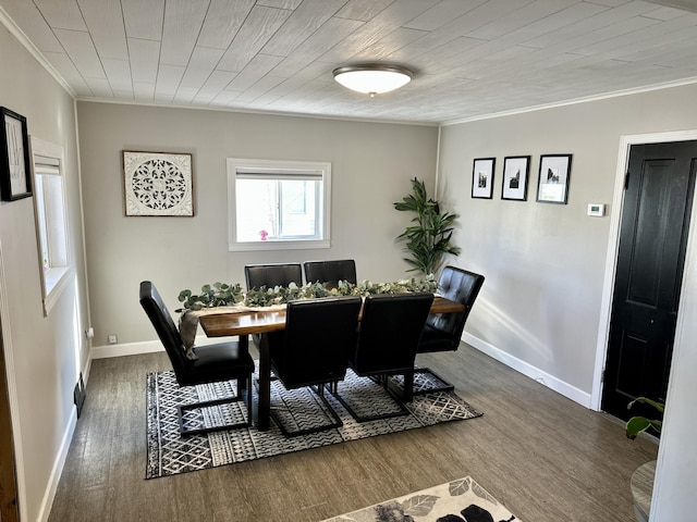 dining room with ornamental molding, wood finished floors, and baseboards