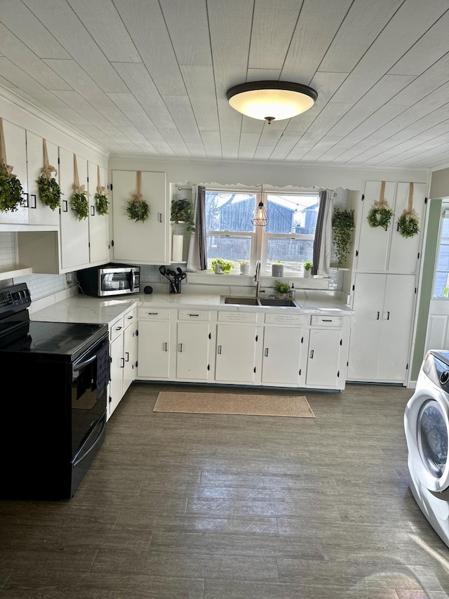 kitchen with dark wood-style flooring, white cabinets, a sink, washer / dryer, and black range with electric cooktop