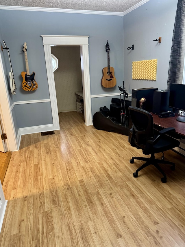 home office with crown molding, a textured ceiling, and light wood-type flooring