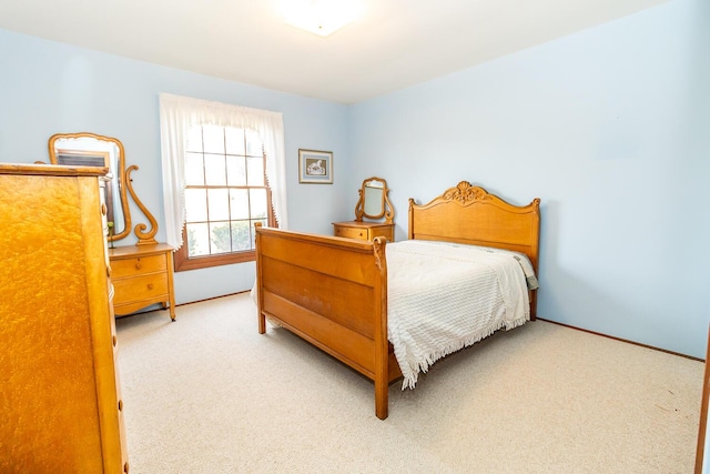 bedroom featuring carpet and baseboards