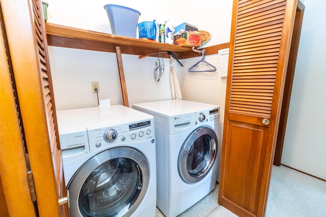 washroom with laundry area, independent washer and dryer, and baseboards