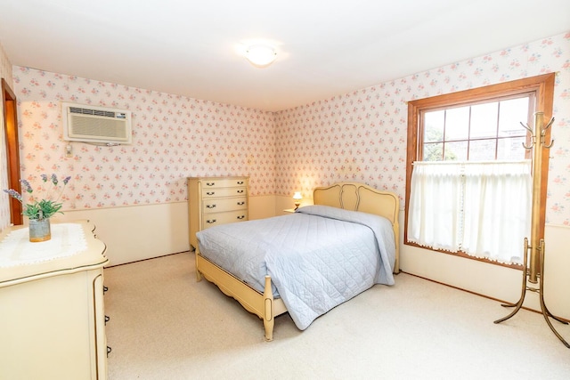 carpeted bedroom featuring wallpapered walls and a wall mounted AC