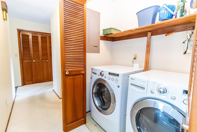 clothes washing area with light carpet, washing machine and dryer, and laundry area