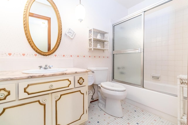 full bath with tile patterned flooring, toilet, wainscoting, enclosed tub / shower combo, and vanity