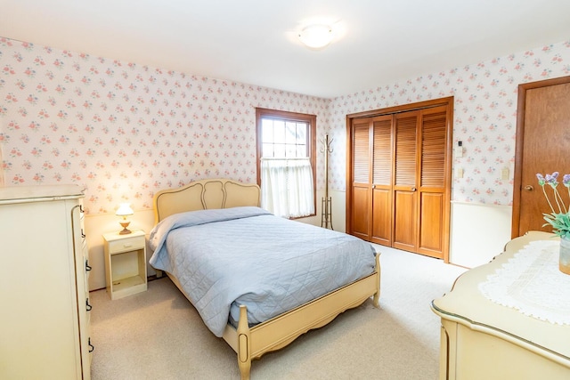 bedroom featuring light colored carpet and wallpapered walls