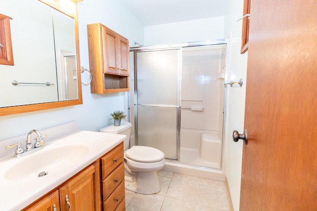 bathroom featuring vanity, toilet, and a shower with shower door