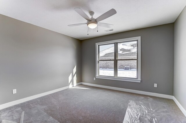 1129 Auburn St, Troy, OH 45373 - carpeted empty room with baseboards, a textured ceiling, visible vents, and a ceiling fan
