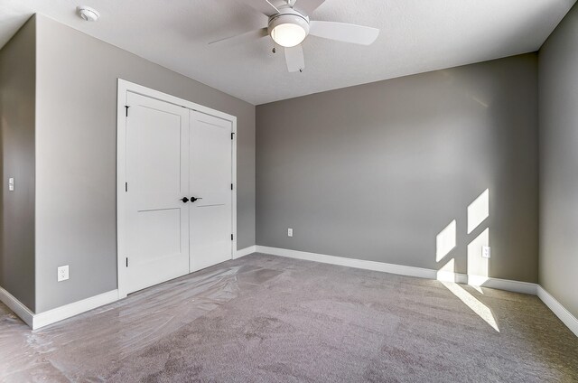 1129 Auburn St, Troy, OH 45373 - unfurnished bedroom with baseboards, a closet, ceiling fan, and carpet flooring