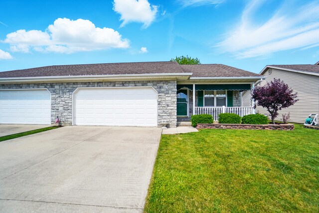 209 Cheyenne Dr, Wapakoneta, OH 45895 - view of front of home featuring covered porch, driveway, stone siding, a front lawn, and an attached garage