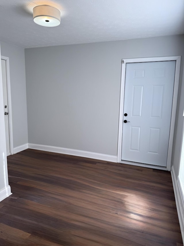 empty room featuring dark wood-type flooring