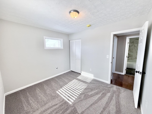 unfurnished bedroom with a closet, carpet, and a textured ceiling