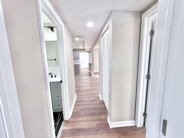 corridor with dark hardwood / wood-style floors and a textured ceiling