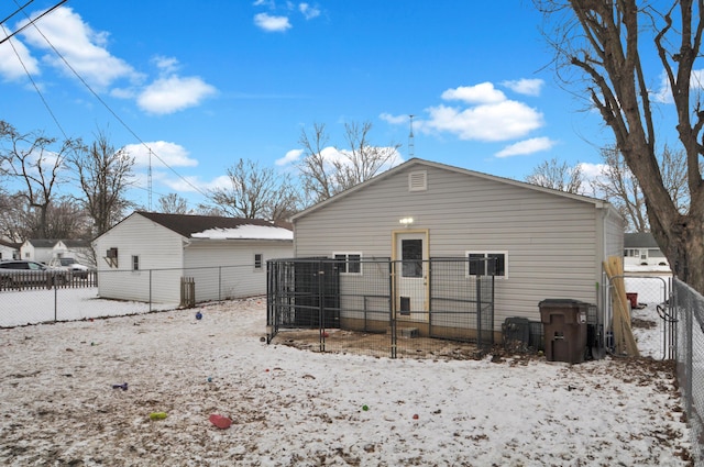 view of snow covered back of property