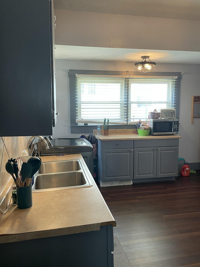 1211 N Lowry Ave, Springfield, OH 45504 - kitchen with stainless steel microwave, dark wood-style flooring, and light countertops