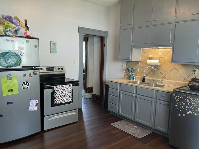 1211 N Lowry Ave, Springfield, OH 45504 - kitchen featuring appliances with stainless steel finishes, gray cabinetry, dark wood-style flooring, backsplash, and light countertops