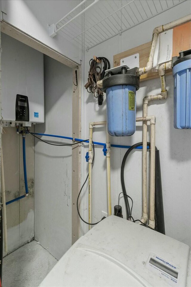 utility room featuring water heater