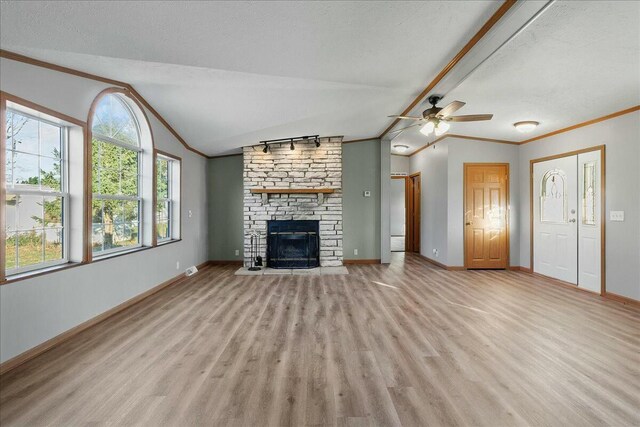 unfurnished living room featuring lofted ceiling, a large fireplace, and a textured ceiling